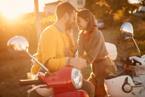 happy couple on scooter enjoying in romantic road trip on vacation