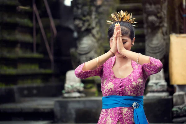 Young woman is praying in Balinese temple during — Stock Photo, Image