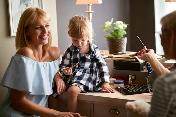 Weibliches Kind in der Familie genießt das Make-up — Stockfoto