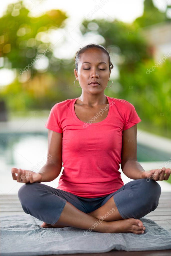 Concentrated woman with close eyes doing yoga