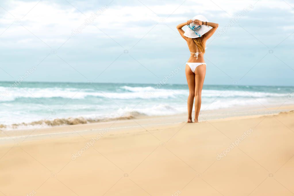 Attractive fit woman in bikini on  beach 