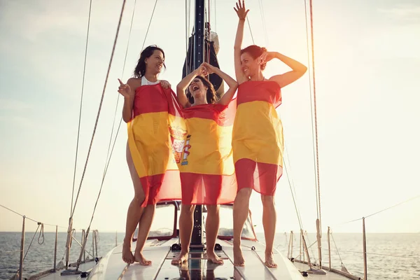Woman on the yacht in Spanish flag having party