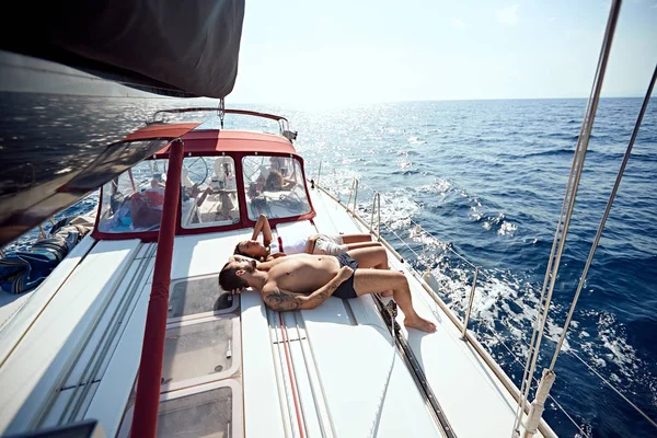Man and woman on boat sunbathing and enjoying on summer day — Stock Photo, Image