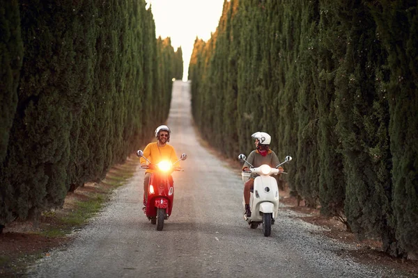 Feliz hombre y chica montando un scooter al aire libre —  Fotos de Stock