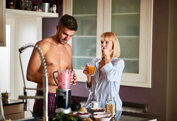 Handsome male with female in the kitchen — Stock Photo, Image
