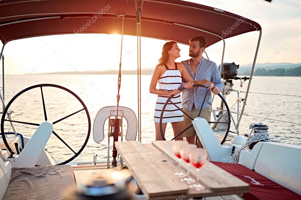 Romantic couple sailing on the luxury boat together and enjoy on vacation