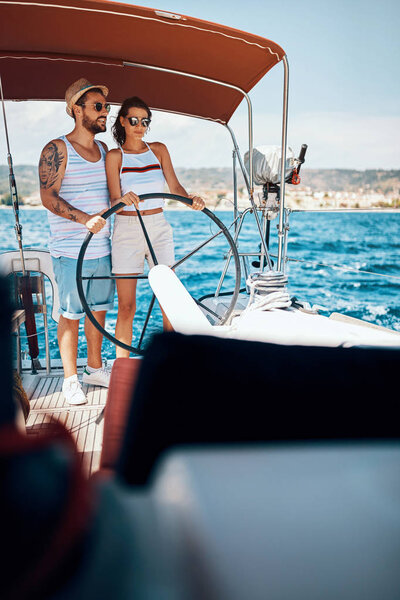 Happy couple having fun on a boat trip