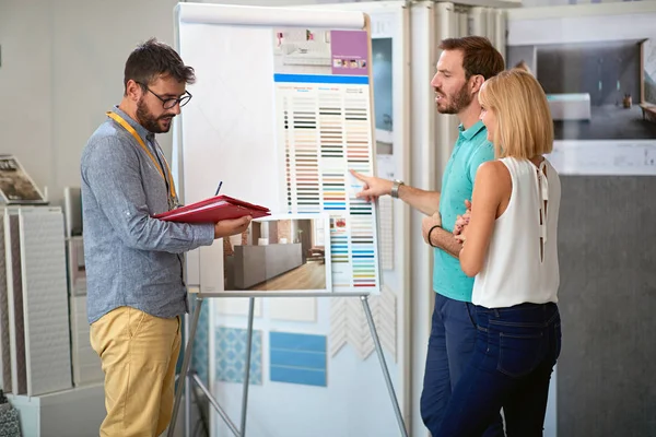 Couple with salesman in store for household — Stock Photo, Image