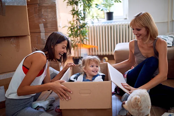 Gay kvinnans med ett småbarn flicka flyttar i nya hem — Stockfoto
