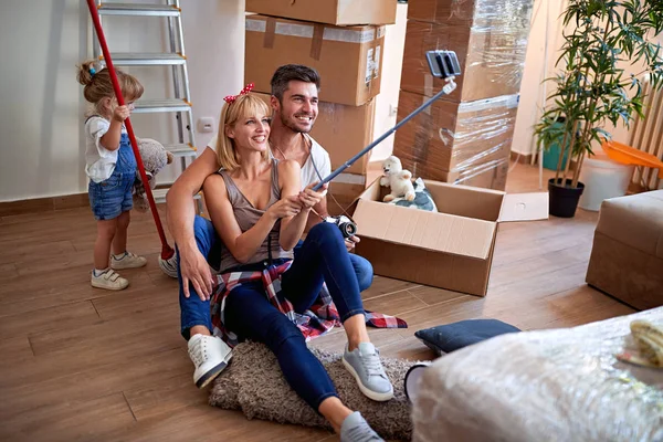Family having fun at new home and taking selfie — Stock Photo, Image