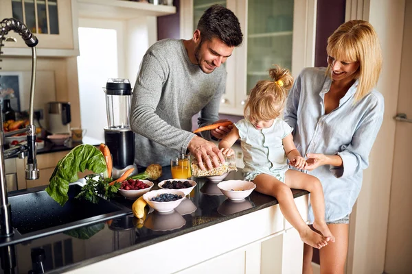 Parents with daughter making breakfast — Stock Photo, Image