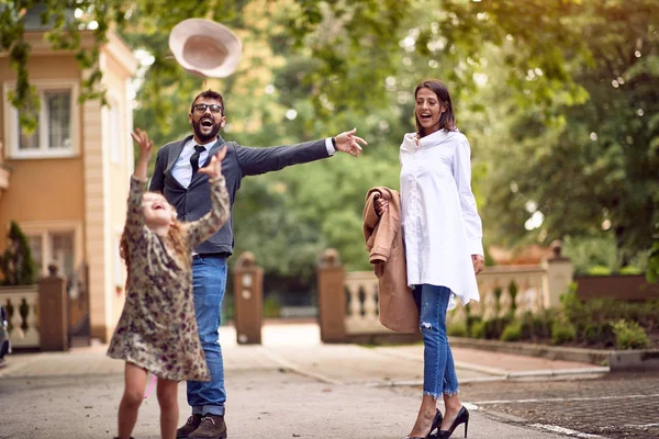 Mother and father with pupil having fun in park after school — Stock Photo, Image
