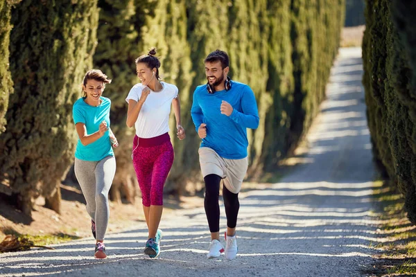 Sportieve vrienden joggen samen outdoor — Stockfoto