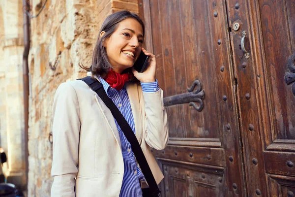 Business woman working and talking on phone at street . — стоковое фото