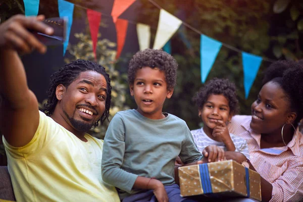 Happy young afro-american family with childs at birthday party have fun and making selfie.
