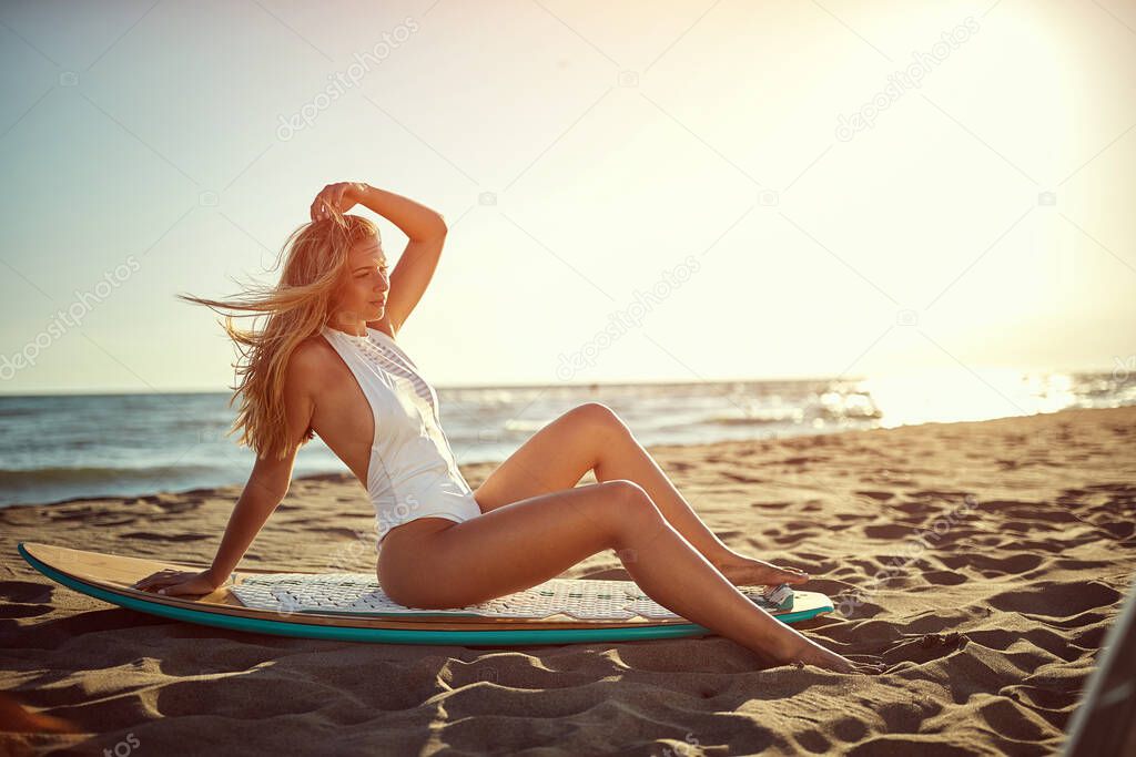 Sexy smiling girl at swimsuit on the beach.Surfer woman. 