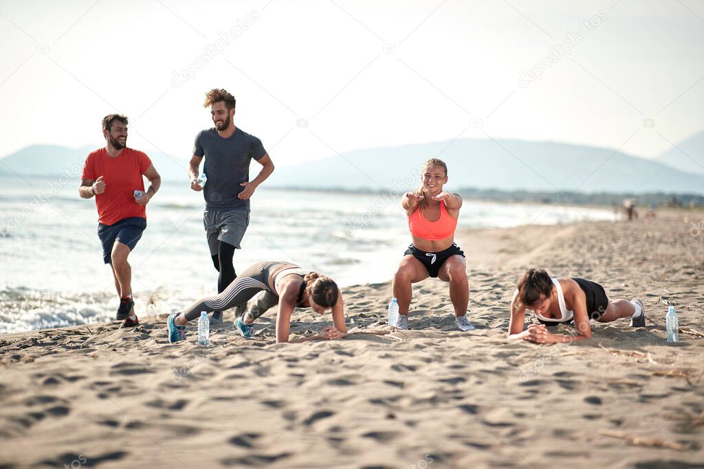 Young people on the beach running and exercise.Healthy lifestyle on vacation.