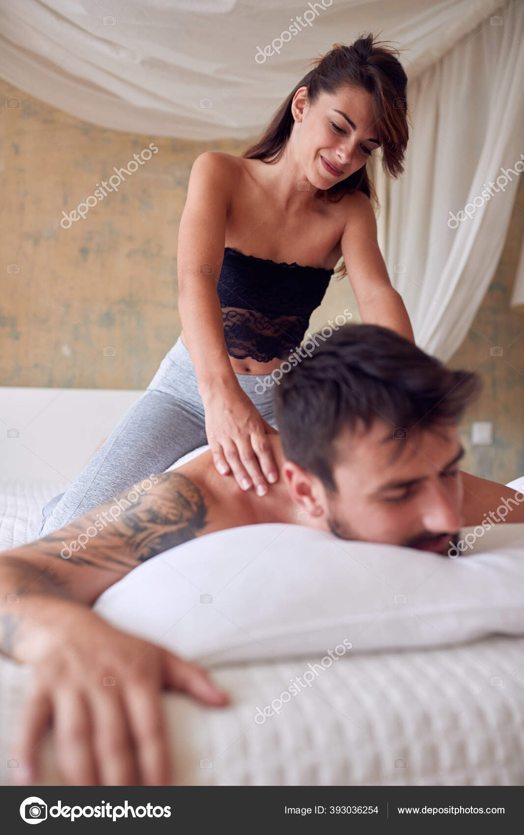 Young Sexy Girl Giving Massage Her Boyfriend Relaxed Atmosphere Bedroom Stock Photo by ©luckybusiness 393036254