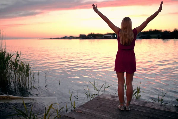 Gölün Kenarında Kollarını Kaldırıp Günbatımının Keyfini Çıkaran Beyaz Bir Kadının — Stok fotoğraf