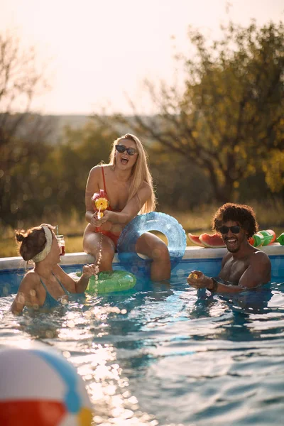 夏休みにプールで水鉄砲を楽しんでいるクレイジーな人々 — ストック写真