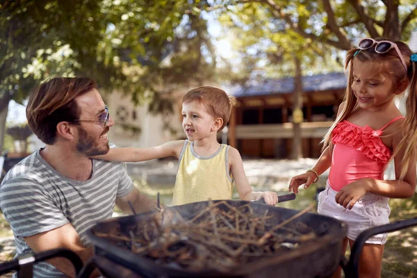 Pai Com Seus Filhos Sorridentes Preparar Fogo Para Churrasco Familiar — Fotografia de Stock