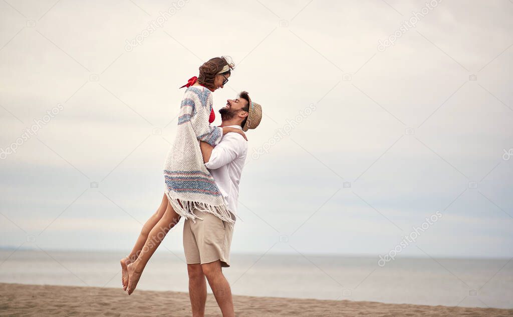 Young couple in love in a romantic moments on the beach on a sunny weather