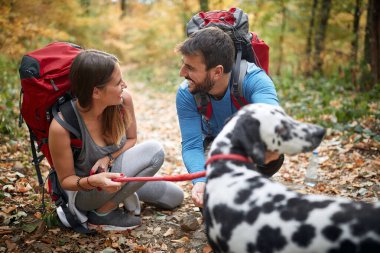 Bir köpekle birlikte yürüyüş yapan çiftler; aktif yaşam tarzı konsepti