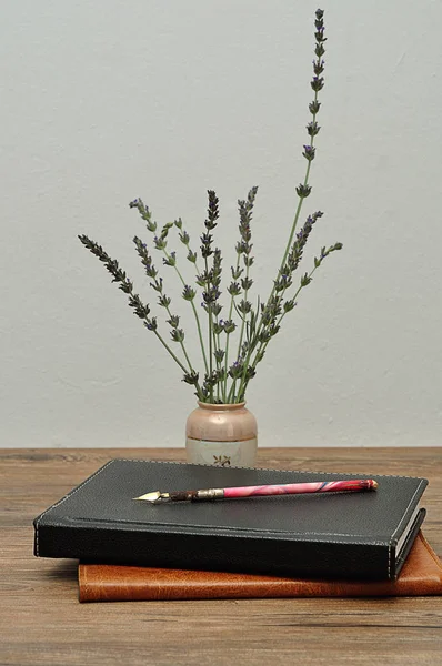 Lavender displayed with note books and a pen