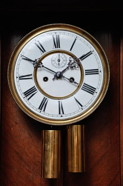 A clock face of an antique clock