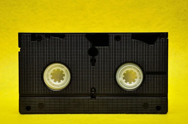 Een videocassette geïsoleerd op een gele achtergrond — Stockfoto