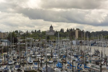 Marina with boats moored in Olympia Washington State by Capitol building on a cloudy day  clipart