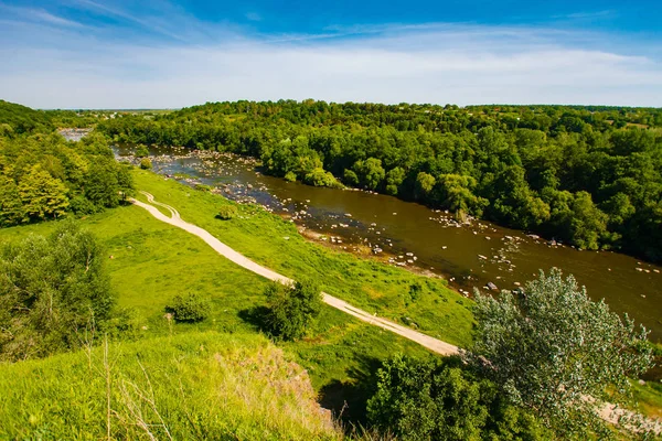 Мелководная Горная Река Протекает Вдоль Зеленой Холмистой Местности — стоковое фото