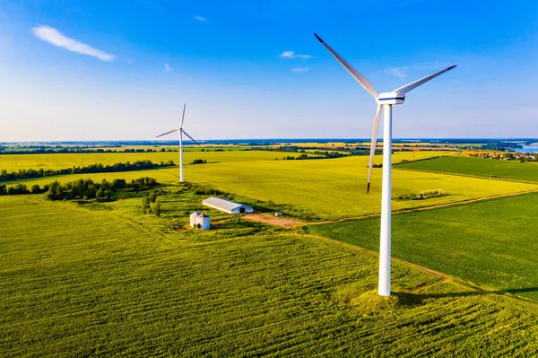 Electricity generation concept. Wind turbines on farmland, aeria landscape