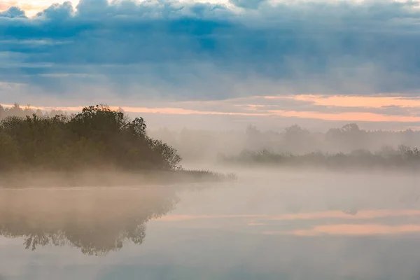 Heavy fog on the river before the rain. Dense fog covers the river and forest in summer