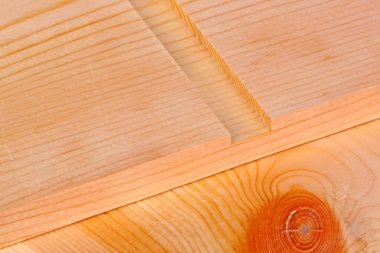 Close-up of a pine board with a freshly routered channel for a woodworking dado joint on a wood background clipart