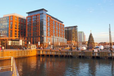 Boats and skyline of buildings at the newly redeveloped Southwest Waterfront area of Washington, DC viewed from the water with Christmas tree in fall clipart