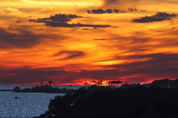 Dramatic sunset over Albemarle Sound as viewed from Jockeys Ridge State Park in the town of Nags Head on the Outer Banks of North Carolina