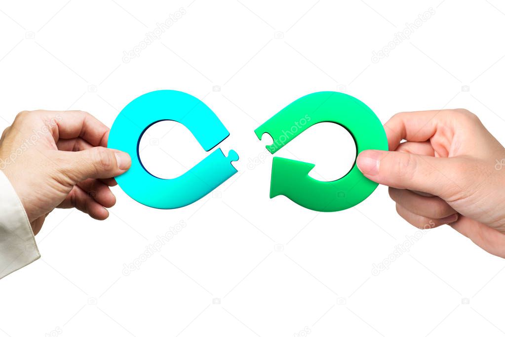 Circular economy concept. Male and female hands assembling arrow infinity recycling symbol of jigsaw puzzle pieces, isolated on white background.
