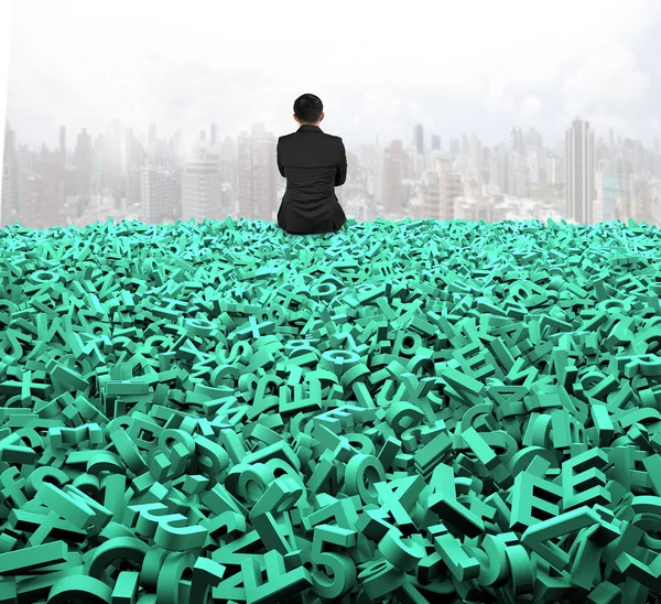 Big data, rear view businessman sitting on huge green characters — Stock Photo, Image