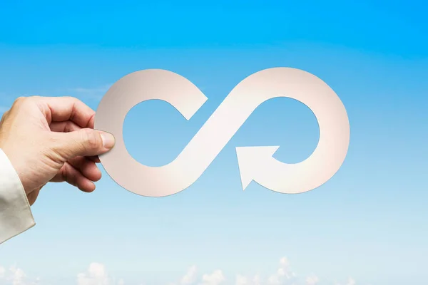 Hand holding arrow infinity recycling symbol, circular economy c — Stock Photo, Image