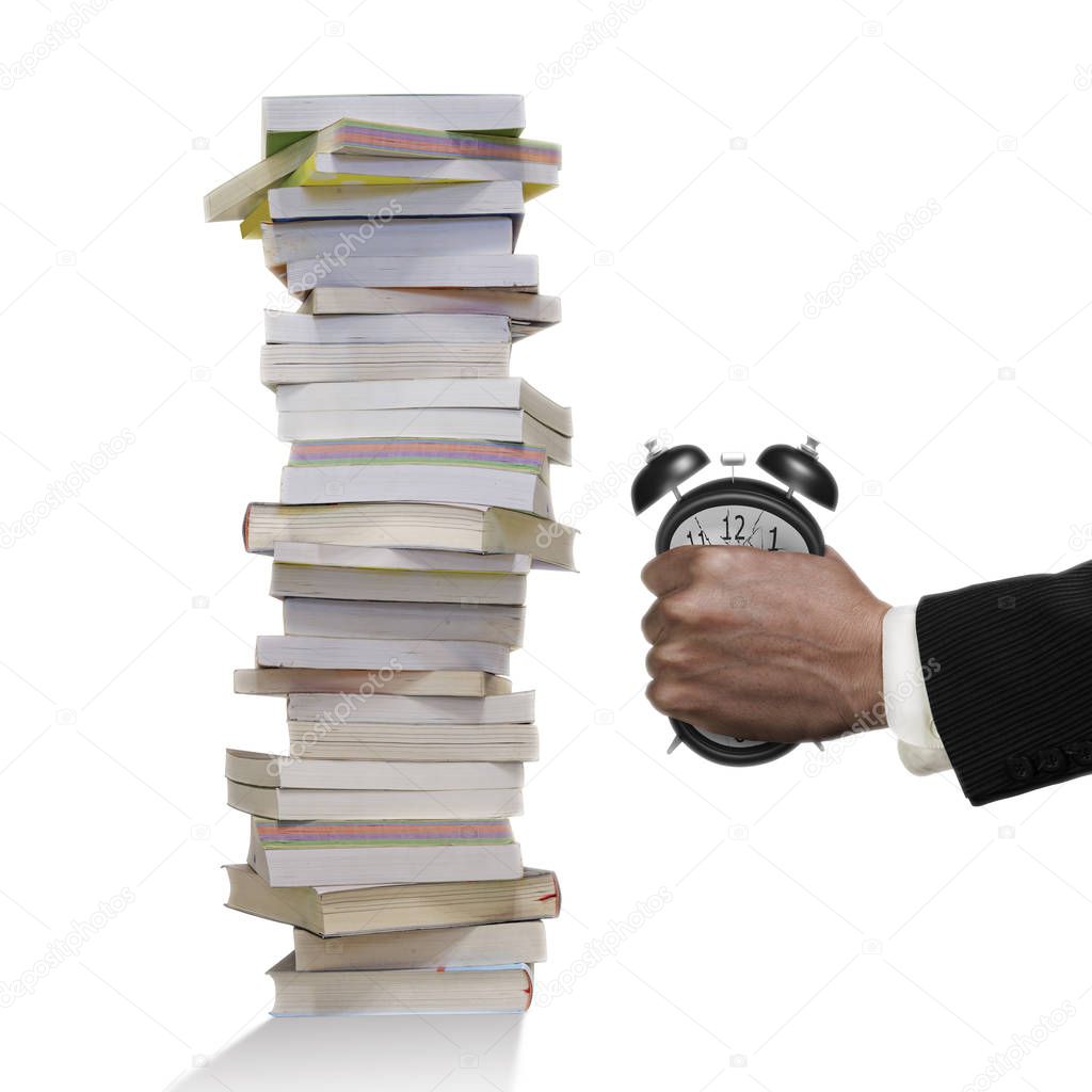 Man's hand seizing alarm clock to deformation with stack books.