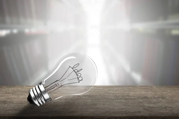 Light bulb with Idea word wire shape on wooden table. — Stock Photo, Image