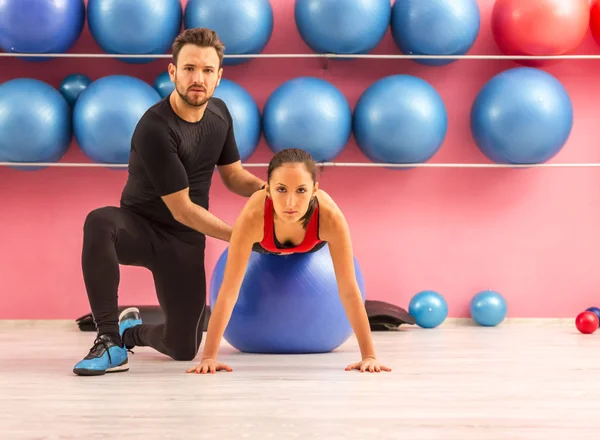 Junge Frau Trainiert Mit Hilfe Ihres Trainers Mit Ball Fitnessstudio — Stockfoto