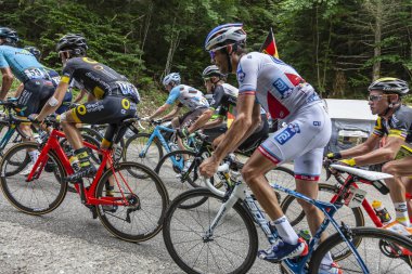 Mont du Chat, France - July 9, 2017: The peloton is climbing the road on Mont du Chat during the stage 9 of Tour de France 2017.  clipart