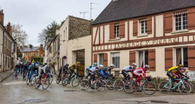 Dampierre-tr-Yvelines, Fransa-4 Mart 2018: Peloton geçer geleneksel binaları önünde bir Fransız köyünde küçük bir sokakta sırasında Paris-Nice 2018