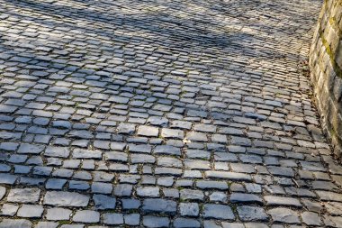 Detail of the famous cobblestone road Muur van Geraardsbergen located in Belgium. On this road every year is organized the famous one day road cycling race Tour of Flanders.  clipart