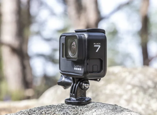 Fontainebleau, France - May 01, 2019: Illustrative image of an action camera GoPro Hero 7 Black outdoors on a rock in a forest.