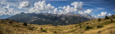 Panoramic image of  the Massif des Ecrins seen from the road climbing to Col du Granon. clipart