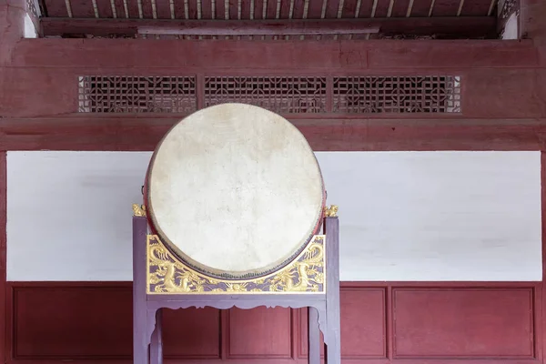 Traditional Chinese big drum on wooden frame with dragon relief in a temple, this traditional drum were usually pounded  in sacrificial rites or festivals in ancient times