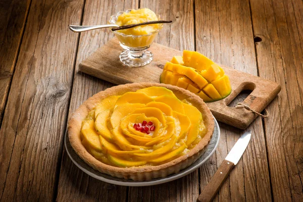 close-up view of mango cake with lemon cream and vanilla stick